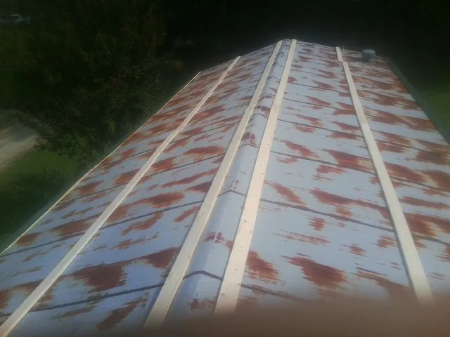 Rusted metal roof panels with new wood purlins before replacement — Storm Damage Roof Repair in Palm Harbor by Roofing Brothers